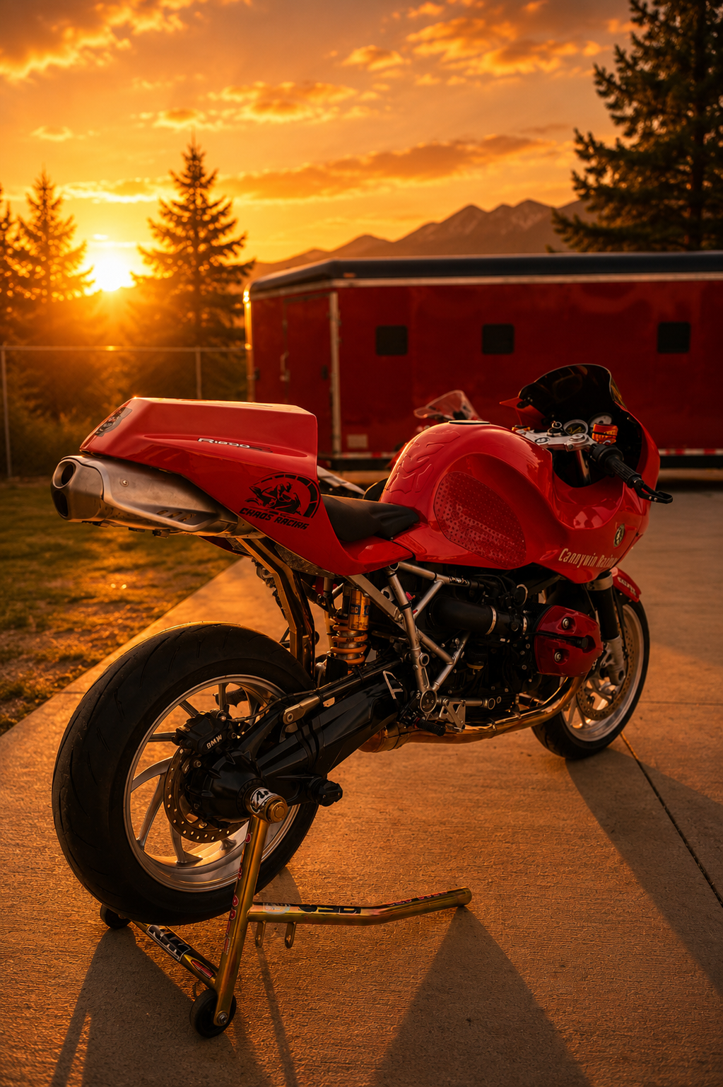 Rear view of the red Cannywin Racing BMW with the race trailer at sunset